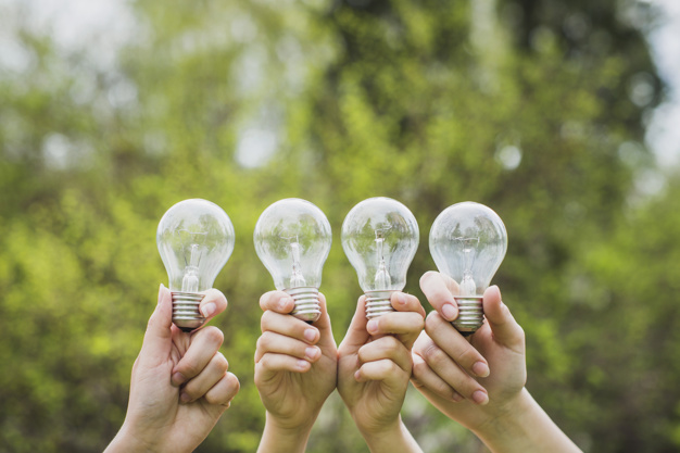 eco-concept-with-hands-holding-light-bulbs_23-2147807281