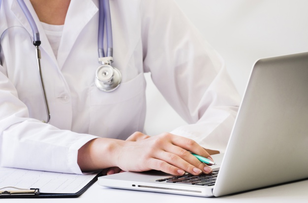female-doctor-with-stethoscope-around-her-neck-using-laptop-desk_23-2148129592