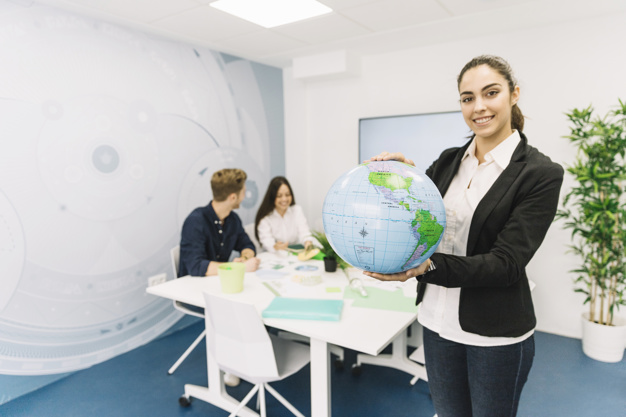 portrait-smiling-young-businesswoman-holding-globe-office_23-2147826583